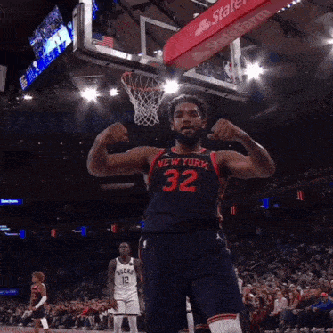 A Basketball Player With The Number 32 On His Jersey Flexes His Muscles GIF