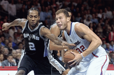 A Basketball Player With The Number 32 On His Jersey Is Dribbling A Basketball GIF