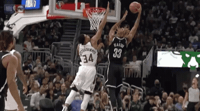 A Basketball Player With The Number 33 On His Jersey Goes Up For A Shot GIF