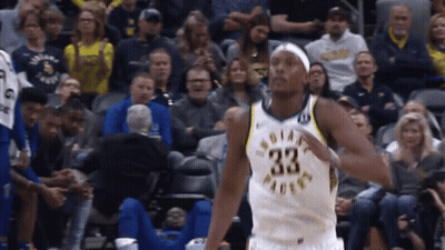 A Basketball Player With The Number 33 On His Jersey Is Standing In Front Of A Crowd GIF