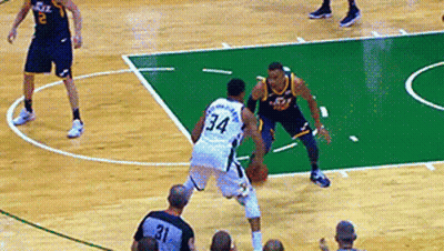 A Basketball Player With The Number 34 On His Back Dribbles The Ball GIF