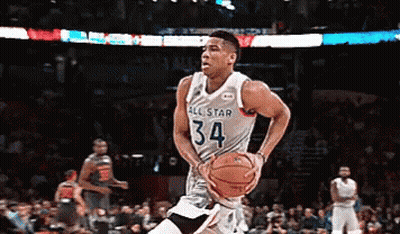 A Basketball Player With The Number 34 On His Jersey Is Dribbling The Ball GIF