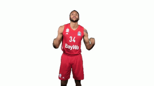 A Basketball Player With The Number 34 On His Jersey Is Flexing His Muscles GIF