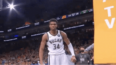 A Basketball Player With The Number 34 On His Jersey Stands In Front Of A Crowd . GIF