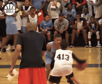 A Basketball Player With The Number 413 On His Jersey Dribbles The Ball GIF