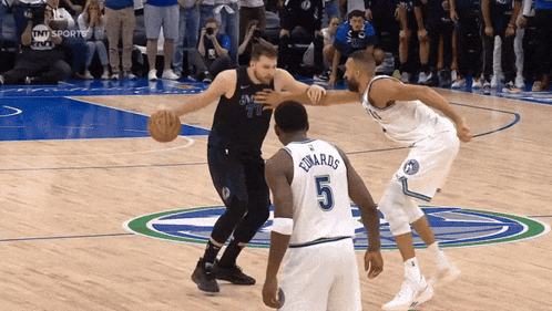 A Basketball Player With The Number 5 On His Jersey Dribbles The Ball GIF