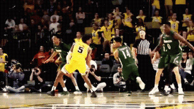 A Basketball Player With The Number 5 On His Jersey Is Being Fouled GIF