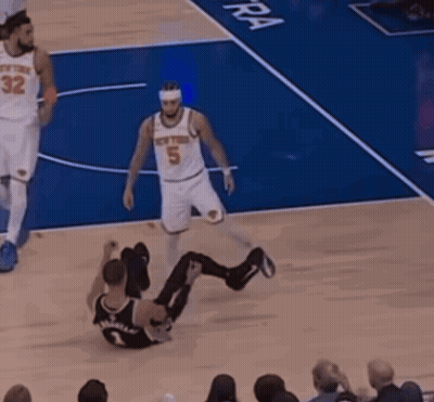 A Basketball Player With The Number 5 On His Jersey Is Sitting On The Floor GIF