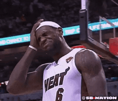A Basketball Player With The Number 6 On His Jersey Is Holding His Head . GIF