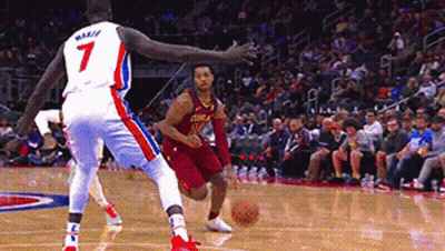 A Basketball Player With The Number 7 On His Jersey Is Dribbling A Basketball GIF