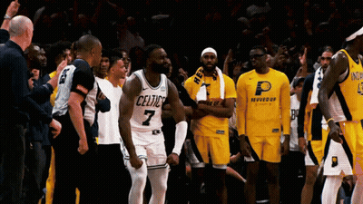 A Basketball Player With The Number 7 On His Jersey Stands In Front Of His Teammates GIF