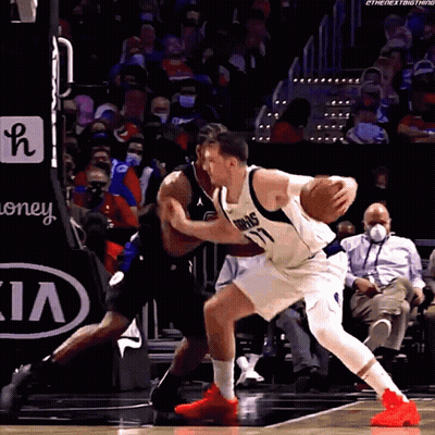 A Basketball Player With The Number 77 On His Jersey Dribbles The Basketball GIF
