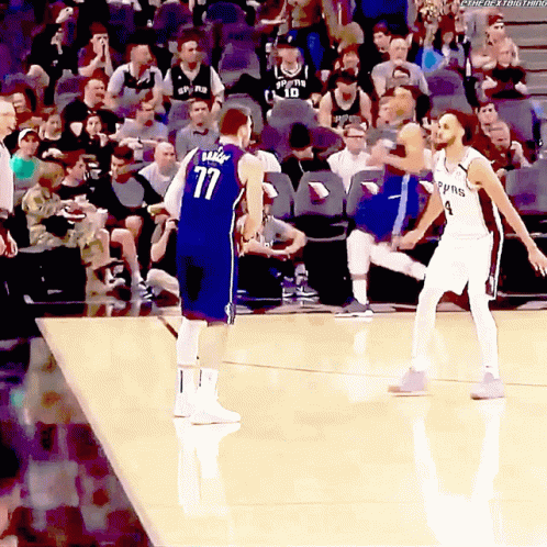 A Basketball Player With The Number 77 On His Jersey Stands On The Court GIF
