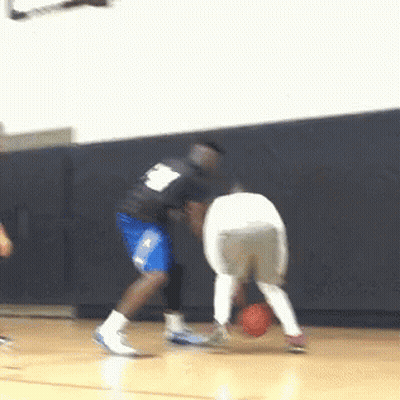 A Basketball Player With The Number 8 On His Back Dribbles The Ball GIF