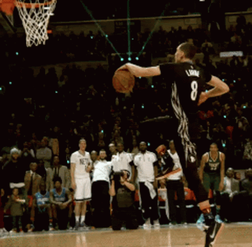 A Basketball Player With The Number 8 On His Back Jumps In The Air GIF