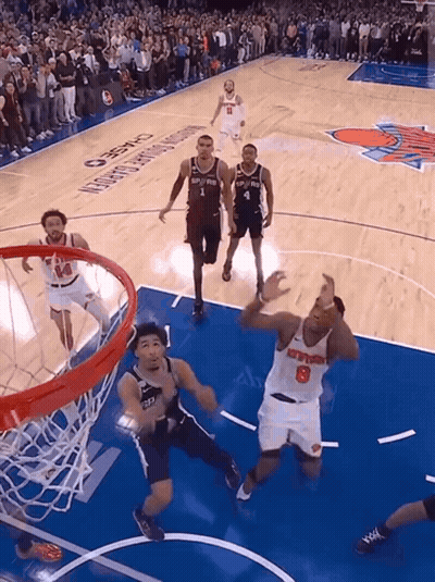 A Basketball Player With The Number 8 On His Jersey Goes For A Dunk GIF