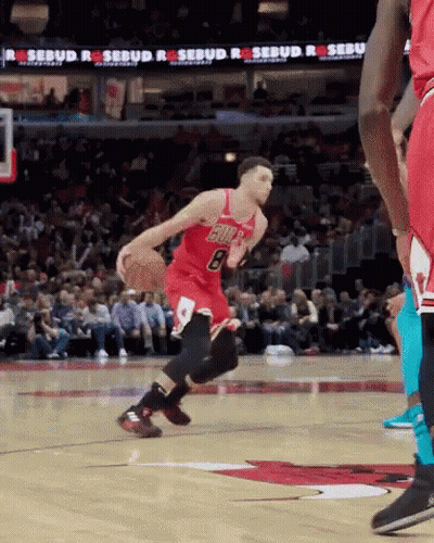 A Basketball Player With The Number 8 On His Jersey Is Dribbling The Ball GIF