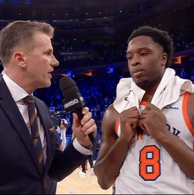 A Basketball Player With The Number 8 On His Jersey Talks To A Reporter GIF