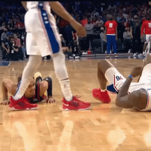 A Basketball Player With The Number 8 On His Shorts Is Crawling On The Floor GIF