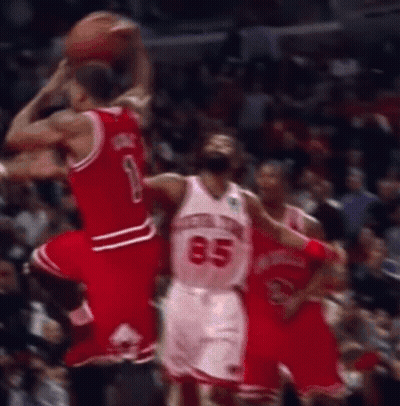 A Basketball Player With The Number 85 On His Jersey Is Jumping To Catch The Ball . GIF