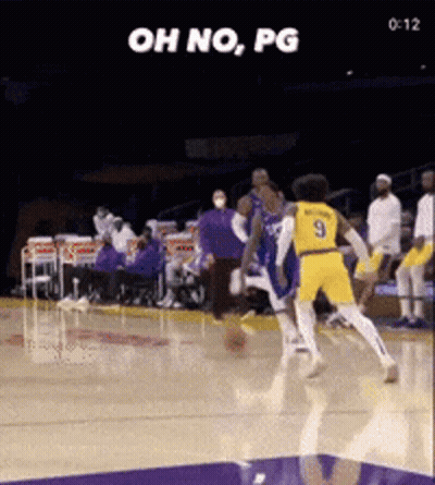 A Basketball Player With The Number 9 On His Jersey Is Trying To Block Another Player GIF
