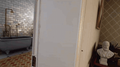 A Bathroom With A Bathtub And A Statue Of A Man On A Table GIF