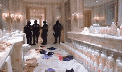 A Bathroom With A Lot Of Baby Bottles And A Few Police Officers GIF