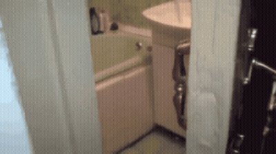 A Bathroom With A Sink And Bathtub And A Door Open GIF