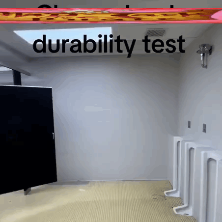 A Bathroom With Urinals And The Words " Durability Test " Above It GIF