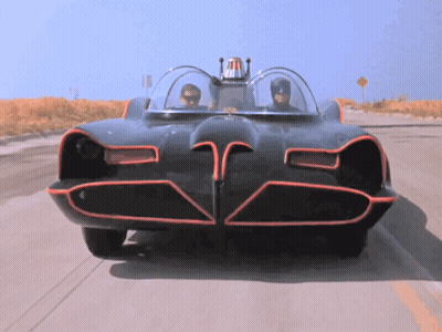 A Batman Car Is Driving Down The Road GIF
