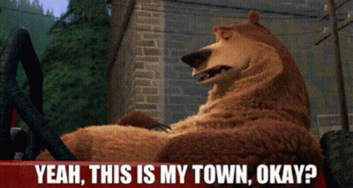 A Bear Is Sitting In A Car With The Words " Yeah This Is My Town Okay " Above Him GIF