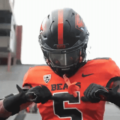 A Bears Football Player Wearing A Black Helmet And Gloves GIF