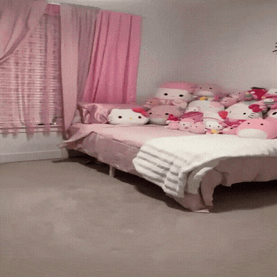 A Bed In A Room With Hello Kitty Stuffed Animals GIF