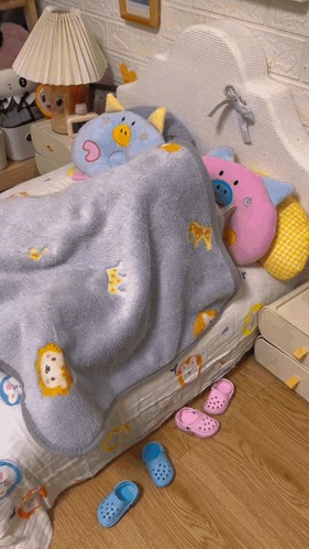 A Bed With A Blue Blanket With A Lion On It GIF