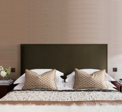 A Bed With Pillows And A Blanket That Says " I Love You " On It GIF