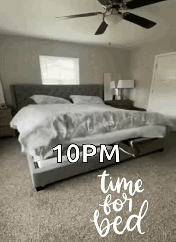 A Bedroom With A Bed And A Ceiling Fan And The Words " Time For Bed " On The Floor GIF