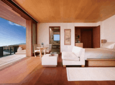 A Bedroom With A King Size Bed And A Couch GIF