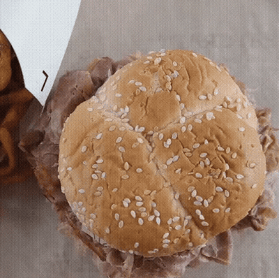 A Beef Sandwich With Sesame Seeds On A Bun GIF