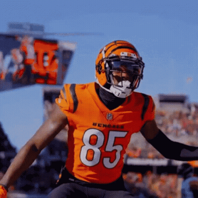 A Bengals Football Player Wearing A Helmet And A Jersey With The Number 85 On It GIF