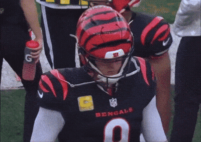 A Bengals Player Wearing A Black Jersey With The Number 9 GIF