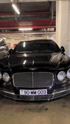 A Bentley Is Parked In A Parking Garage With A License Plate Reading 90-Mm-009 GIF