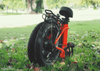 A Bicycle Is Folded Up And Sitting In The Grass With Imgflip.com Written On The Bottom GIF