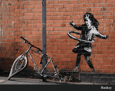 A Bicycle Is Parked In Front Of A Brick Wall With A Painting Of A Girl With A Hula Hoop GIF