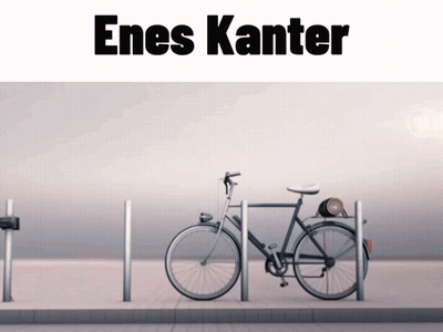 A Bicycle Is Parked In Front Of A Sign That Says Enes Kanter On It GIF