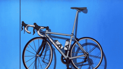 A Bicycle With A Purple Background And A Purple Glow GIF