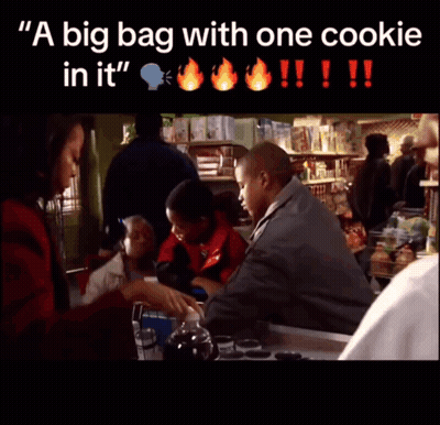 A Big Bag With One Cookie In It Is Being Held By A Man GIF