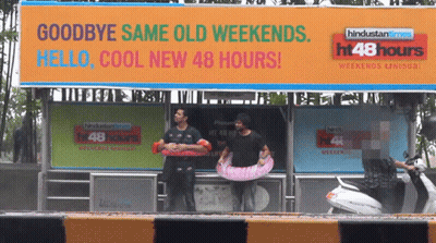A Billboard That Says Goodbye Same Old Weekends GIF