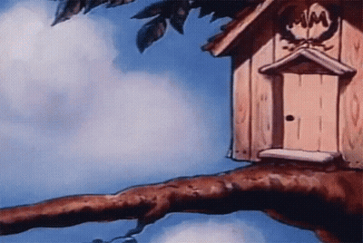 A Birdhouse Is Sitting On A Tree Branch With A Blue Sky In The Background GIF