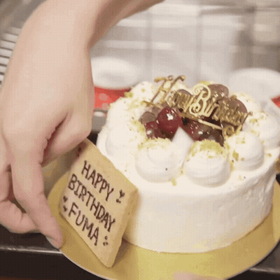 A Birthday Cake With A Sign That Says Happy Birthday Fuma On It GIF