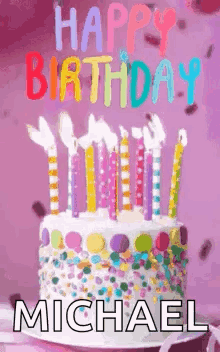 A Birthday Cake With Candles And Confetti On It And The Name Michael On It . GIF